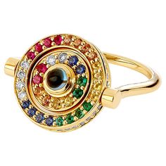 Created in 18 karat yellow gold London blue topaz 0.40 carat approx. Emeralds, multicolor sapphires, rubies Diamonds 0.90 carat approx. Ring size US 7, can be sized as per request Swivel mechanism and reversible Limited edition Crafted with 18 karat yellow gold, this exclusive and limited edition ring features a swivel mechanism and reversible design. At the center lies a luminous London blue topaz of approximately 0.40 carat. Surrounding it are mesmerizing emeralds, multicolor sapphires, rubies People Working Together, Gold Topaz, Gold Cocktail Ring, Contemporary Ring, Gold Cocktail, Ruby Diamond, Garnet Rings, London Blue Topaz, London Blue