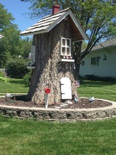 a tree stump with a house built into it