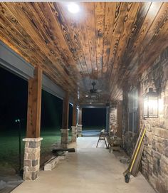 the inside of a building that is being built with wood planks and stone columns