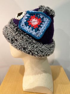 Introducing our unique Hand-Knitted Patchwork Hat, designed to keep you warm and stylish throughout the colder months. Each hat is carefully crafted with the following features: 1. **One Size Fits Most Designed to comfortably fit a variety of head sizes, our hand-knitted hat offers a snug and cozy feel for everyone.     2. **Patchwork Detail The front and back of the hat showcase intricate patchwork designs, adding a vibrant and artistic touch to your winter wardrobe. Each patchwork piece is uni Purple Crochet Winter Hat, Brimmed Knit Crochet Hat For Winter, Outdoor Knit Crochet Cap, Winter Purple Knitted Hat, Handmade Crochet Yarn Hat For Cold Weather, Knit Crochet Cap For Cold Weather, Winter Crochet Hat In Acrylic Yarn, Outdoor Brimmed Crochet Hat, Outdoor Crochet Yarn Hat