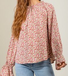 Step into sophistication with this luxurious blouse, crafted from a soft and lightweight 100% polyester. The classic mock neck is enhanced with a delicate back tie detail, while the bell sleeves exude elegance. A timeless floral print adorns the raglan sleeve silhouette with a stunning finish. Sleeve Silhouette, Floral Top, Raglan Sleeve, Mock Neck, Bell Sleeves, Floral Tops, Shirts Tops, Floral Print, Floral Prints