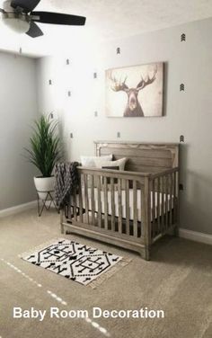 a baby's room with a crib, rug and painting on the wall