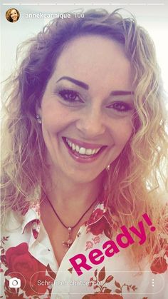 a woman smiling and wearing a flowered shirt with the words ready on her chest