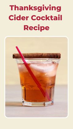 a glass filled with liquid and a cinnamon stick sitting on top of it, next to a