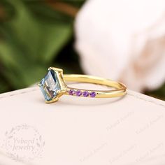 "Please confirm your US size when you make an order) Jewelry Details -Gold Type : 14k gold Center Stone: NATURAL London Blue Topaz, Approximately 2.0ct Stone Size: 7*8mm Cut: Kite Cut (Long Rhombus) Side Stones: NATURAL Amethyst Total weight: 0.12 ctw Band Width: Approximately 1.4mm SKU: YR0519-E ~*-*~Purchase Guarantee: - All our jewelry is handmade, and each process is refined. - 14 Day Refund Guarantee. - All our products are Free Shipping. - Free Gift Box&Packing. ~*-*~Please contact us 14k Gold Amethyst Promise Ring With Gemstone Accents, 14k Gold Topaz Promise Ring With Gemstone Accents, 14k Gold Topaz Ring With Gemstone Accents For Promise, 14k Gold Topaz Ring With Accent Stones For Promise, Blue Amethyst Wedding Ring, London Blue Topaz Engagement Ring, Gold Ring Band, Blue Topaz Engagement Ring, Jewelry Details