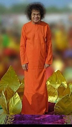 a man in an orange outfit standing next to gold foil