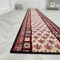 a red and black runner rug on the floor