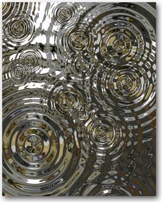 an abstract image of silver circles on a metal surface