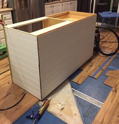 an unfinished kitchen cabinet is being built in the process of being installed on the floor