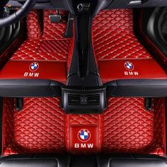 the interior of a bmw car with red leather floor mats