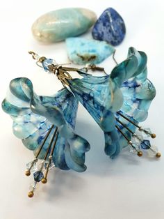 Large Aqua And Denim Blue Flower Earrings ~ Mermaid Flowers ~ Handpainted Lucite Flower Earrings, Handmade Bohemian Boho Hippy Floral Earrings, Unique Gift For Her. ~ Mermaid Flowers ~ ♡ These beautiful Lucite flower earrings are painted in calming hues of Aqua Blue, Sky Blue and Denim Blue, with a subltle golden shimmer on the petal tips. Little matching Moonstone crystals and Czech glass beads in Milky Blue sit alongside Swarovski crystals in Denim Blue. The French hooks are Nickle free low al Mermaid Flowers, Blue Flower Earrings, Lucite Flower Earrings, Flowers Handmade, Moonstone Crystal, Bohemian Floral, Earrings Unique, Unique Gifts For Her, Hippie Bohemian