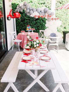 a white table topped with plates and cups