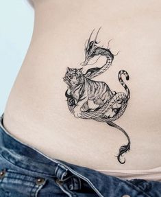 a woman's stomach with a tiger tattoo on it