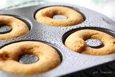 four donuts in a muffin tin ready to be baked