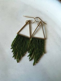 Green seed bead earrings combined with a brass triangle finding. Gold Triangle Beaded Bohemian Earrings, Beaded Fringe, Seed Bead Earrings, Fringe Earrings, Bead Earrings, Beaded Dangles, Minimalist Earrings, Seed Bead, Green And Gold