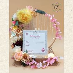 the wedding certificate is surrounded by flowers and feathers