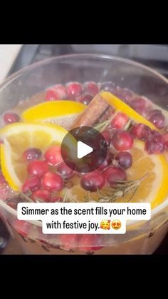 a bowl filled with fruit and spices on top of a counter next to an orange slice