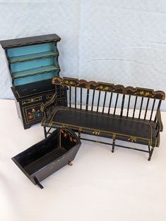 three pieces of furniture sitting on top of a white table next to an open box