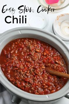 easy slow cooker chili recipe in a crock pot with a wooden spoon on the side