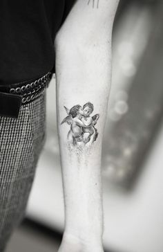 a woman with a tattoo on her arm is holding onto another person's arm