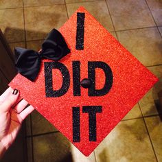 a red graduation cap with the words i did it written on it and a black bow