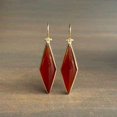 Rich vermillion color balances elegance with extravagance in these strikingly structured carnelians. 18k yellow gold Carnelian, 31.8ctw, 11mm x 38mm (7/16" x 1 1/2")Earrings hang 2 1/16" from the ear Each earring weighs 5.3g Formal Red Carnelian Jewelry, Modern Carnelian Jewelry For Formal Occasions, Luxury Carnelian Jewelry For Formal Occasions, Formal Yellow Gold Chalcedony Jewelry, Elegant Carnelian Dangle Earrings, Elegant Carnelian Jewelry For Formal Occasions, Gold Carnelian Gemstone Earrings, Elegant Carnelian Drop Earrings, Elegant Carnelian Teardrop Earrings