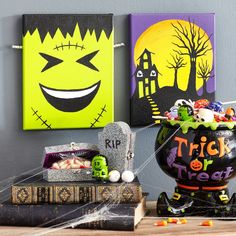 halloween decorations are displayed in front of two canvass with the words make the look