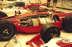 an old race car is on display in a museum