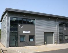 an industrial building with garage doors and windows