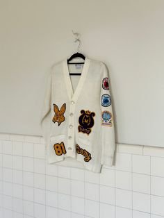 "a 1981 letterman's cardigan from mesa high schools band. belonged to flutist,  terry. patches on front include bunny mascot, \"terry\" and mesa band. sleeve patches include a flute in right arm. left arm has  two rodeo patches from 1970s and a patch from 1980s cherry blossom festival in washington. back has mesa high patch. in amazing vintage condition with no rips, tears or stains. All buttons are original and  patches are sewn on tightly. See all pictures for close-up detail. material :acrylic  measurements are taken with garment lying flat.  chest 38' length 26' sleeve 23' shoulder 6'" Bunny Mascot, Patch Sweater, High School Band, Cherry Blossom Festival, High Schools, Jumpers And Cardigans, Cardigans For Women, Rodeo, Cherry Blossom