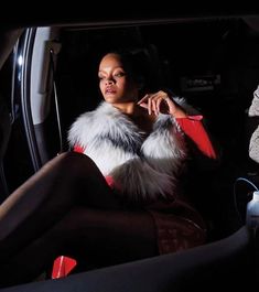 a woman sitting in the back seat of a car