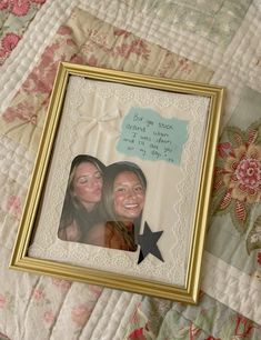 two women are smiling and one is holding a star in front of the other with a message on it