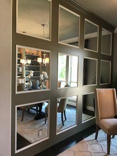 a living room filled with lots of furniture and mirrors on the side of it's wall