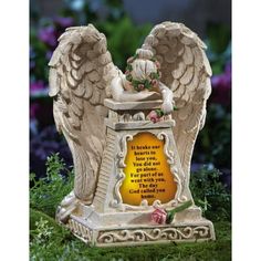 an angel figurine with a poem written on the front and back wings, sitting in grass