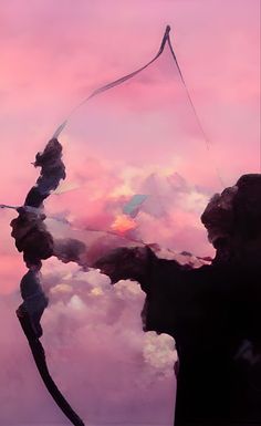 a person flying a kite in the sky with pink clouds behind them and an orange sun