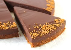 pieces of chocolate cake with crumbs on top and one slice cut in half