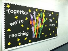 a bulletin board with handprints and stars on it that says together we're reaching for the stars