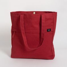 The Terra Thread Executive work tote bag is designed for both functionality and sustainability. It’s large enough to fit all your office essentials, sturdy enough to stand on its own for easy loading, and features a convenient snap closure. Crafted from Fairtrade Certified organic cotton, this tote is perfect for those seeking sustainable options. With an internal laptop compartment, an internal pocket for a water bottle, a large external zippered pocket, and a divided external drop-in pocket, this bag helps you stay organized every day. Your purchase also supports Feeding America's campaign to end hunger by donating meals to kids and families in need. As these products are handmade, slight visible imperfections and size variations may occur. Made in a Fair Trade Certified™ factory in Indi Everyday Canvas Tote Bag With Flat Pocket, Eco-friendly Everyday Bags, Practical Cotton Shoulder Bag With Reinforced Handles, Functional Everyday Red Bag, Modern Cotton Shoulder Bag With Pockets, Red Canvas Bag With Double Handle For Everyday Use, Red Double Handle Canvas Bag For Everyday Use, Functional Cotton Canvas Bag For Everyday Use, Functional Everyday Cotton Canvas Bag