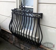 a window sill on the side of a house with wrought iron bars and windowsills