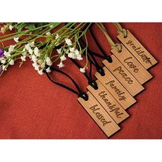 four wooden name tags with flowers on red cloth next to eachother that says, together we love you forever