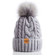 a grey hat with a pom - pom on top and a white background