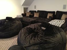 a living room with bean bag chairs and couches in the middle of the room