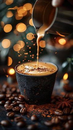 coffee being poured into a cup on top of roasted coffee beans with christmas lights in the background