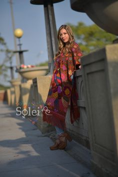 "This beautiful full body Mexican poncho is handmade by Cross Stitch both in the front and in the back. The colorful floral design will add style to your wardrobe and keep you warm too! One size fits all: From extra small to 2x It measures 47\" Long and 31.5\" wide" Red Folk Style Poncho For Fall, Hippie Poncho With Tassels, Spring Festival Poncho Cape, Spring Festival Cape Poncho, Red Long Sleeve Poncho For Festival, Spring Festival Poncho, Red Cape Poncho For Festival, Folk Style Poncho For Fall, Bohemian Red Shawl Cape