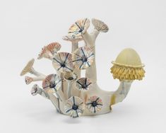 a ceramic figurine with shells and flowers on it