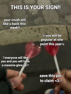 someone holding two lollipops in their hands with the text, this is your sign