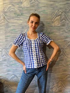 "Ruffle Dirndl Blouse Blue Plaid Blouse Women Summer Top Short Puff Sleeve Button up Blouse Trachten Austrian Folk Blouse Size Medium  Label size: 38 Estimated size: M Measurements: (lying flat) Length: 23\" / 58 cm Pit to pit: 17,5\" / 45 cm (adjustable) Waist: 17\" / 43 cm (adjustable) Sholders: 13\" / 33 cm Sleeve: 13\" / 33 cm Please check measurements to insure a proper fit. Remember to allow yourself some extra room for movement. You can compare these with something from your closet that f Blue Puff Sleeve Top With Button Closure, Vintage Blue Blouse With Button Closure, Blue Vintage Blouse With Button Closure, Blue Retro Blouse With Buttons, Retro Blue Blouse With Buttons, Dirndl Blouse, Short Puff Sleeve, Plaid Blouse, Womens Tops Summer