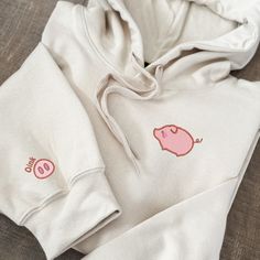 🐷 Embroidered Pig Hoodie- Oink-tastic Style for Pig Lovers! 🌾 Snuggle up in style and showcase your love for these charming oinkers with our exclusive Embroidered Pig Hoodie. Featuring an adorable embroidered pig design and a whimsical pig nose detail on the sleeve, this cozy hoodie is the perfect way for pig lovers to express their passion with flair. 🔍 Key Features: ✨ Delightful Pig Embroidery: The hoodie boasts a detailed and endearing embroidered pig design that captures the essence of th Cute Embroidered Hoodie For Streetwear, Cute Fleece Hoodie Sweatshirt, Cute Cotton Hoodie With Kangaroo Pocket, Cute Fall Sweatshirt With Kangaroo Pocket, Cute Long Sleeve Hoodie With Kangaroo Pocket, Cute Hoodie Sweatshirt With Kangaroo Pocket, Cute Embroidered Long Sleeve Hoodie, Cute Fleece Hoodie With Crew Neck, Cute Fleece Crew Neck Hoodie