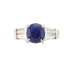 an oval blue sapphire and baguette diamond ring