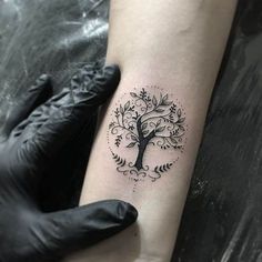 a small tree tattoo on the arm